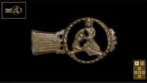 Circa 15th century AD. An openwork bronze strap end comprising a trapezoidal plate .jpg